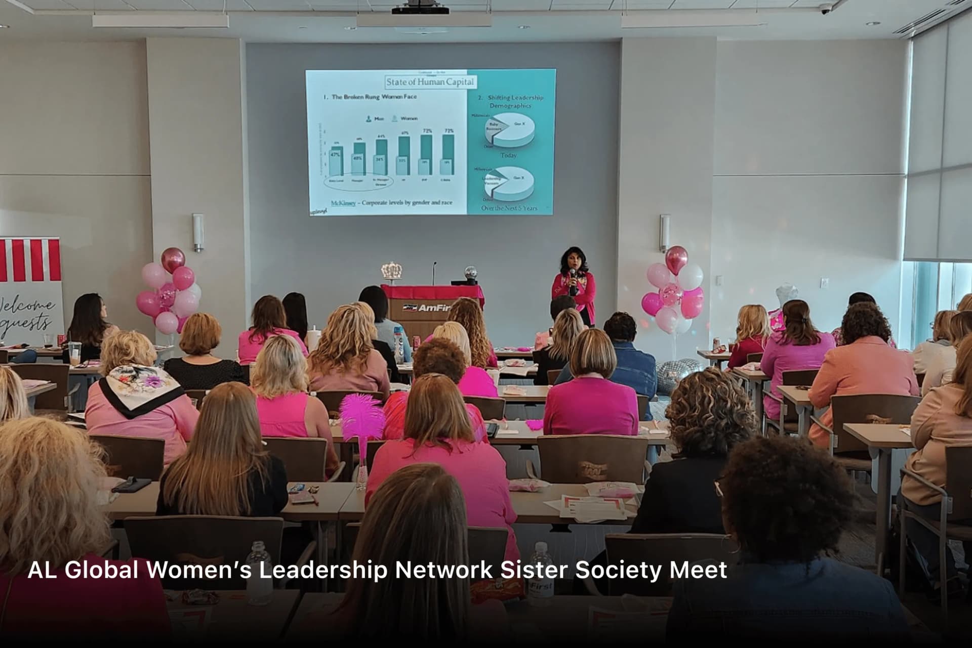 Shubhi Rao presenting to a room of women dressed in pink at the AL Global Women’s Leadership Network Sister Society meet