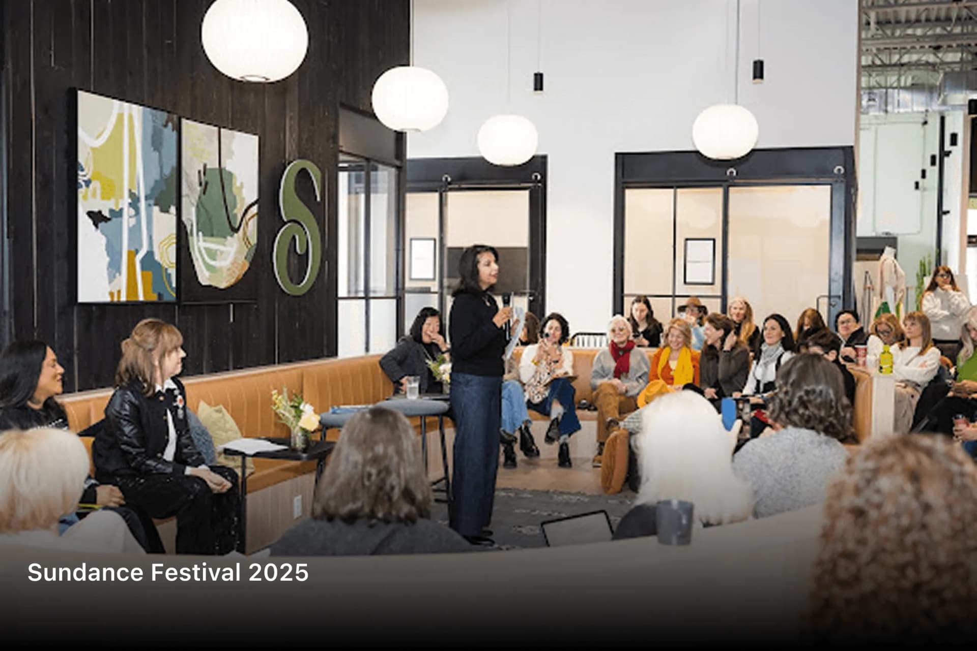 Shubhi Rao addressing a seated audience in a lounge at Sundance Festival 2025