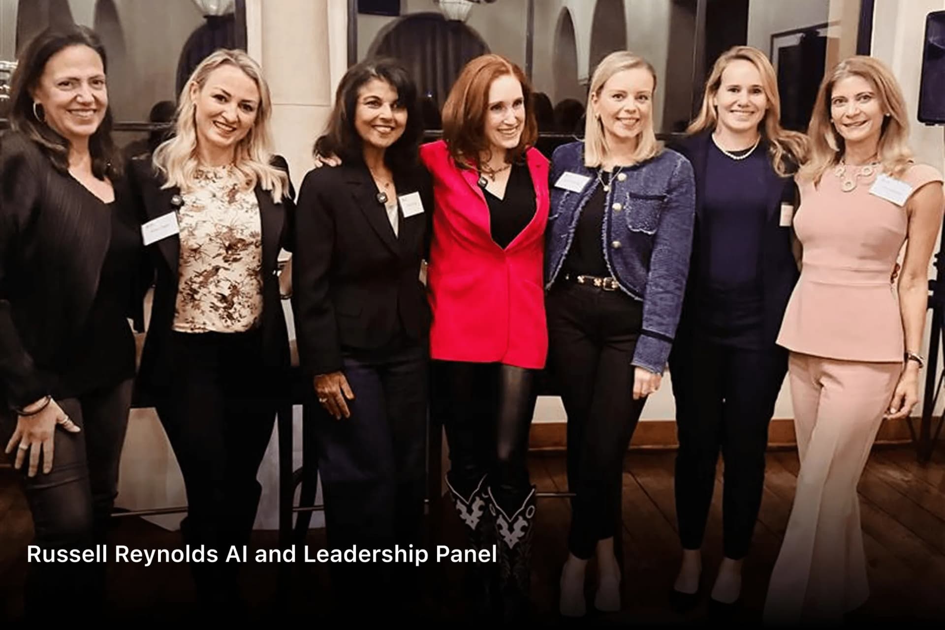 Seven women panellists standing together at the Russell Reynolds AI and Leadership panel