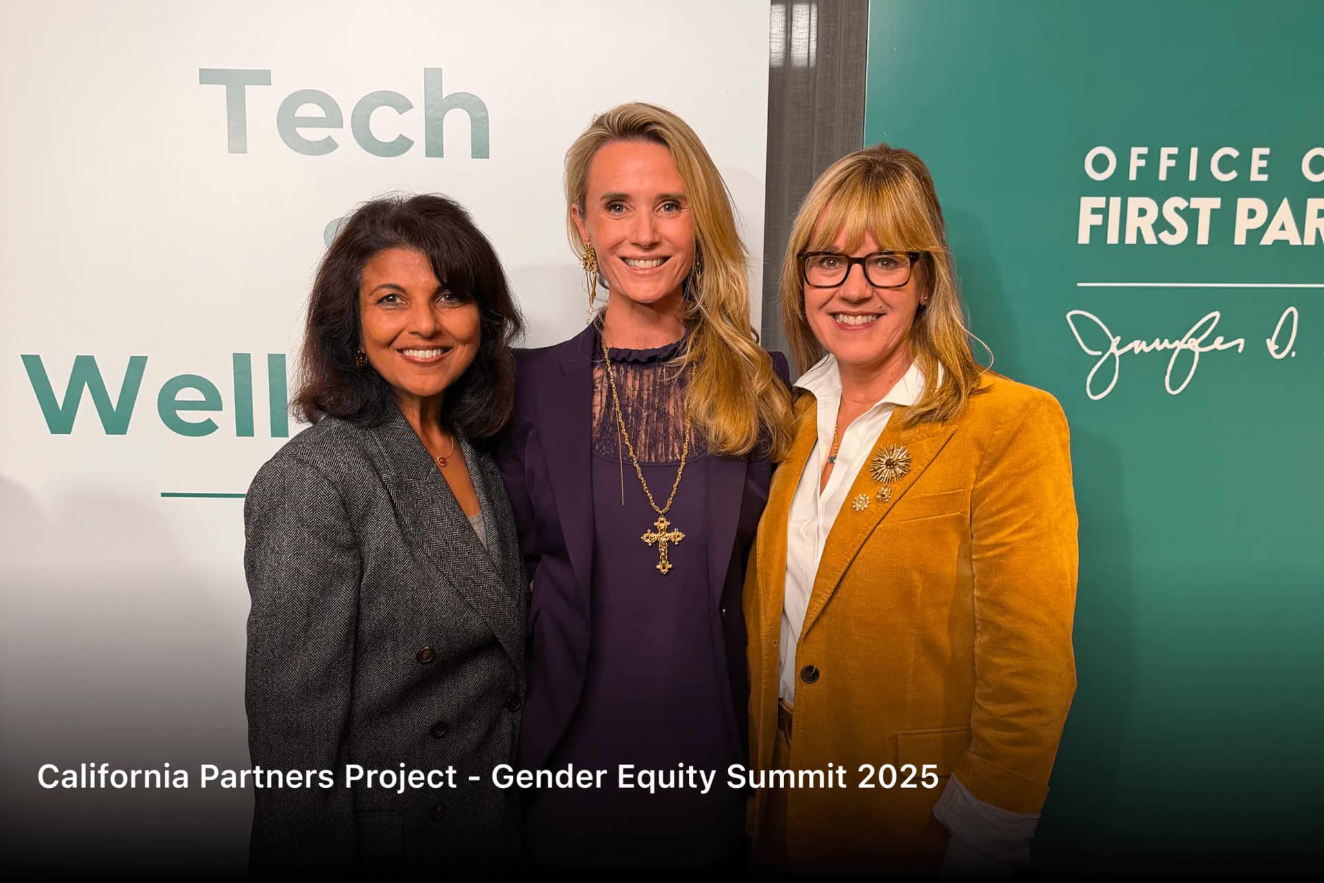 Shubhi Rao with two women in front of the Tech & Well-Being and Office of the First Partner backdrop at the California Partners Project Gender Equity Summit 2025