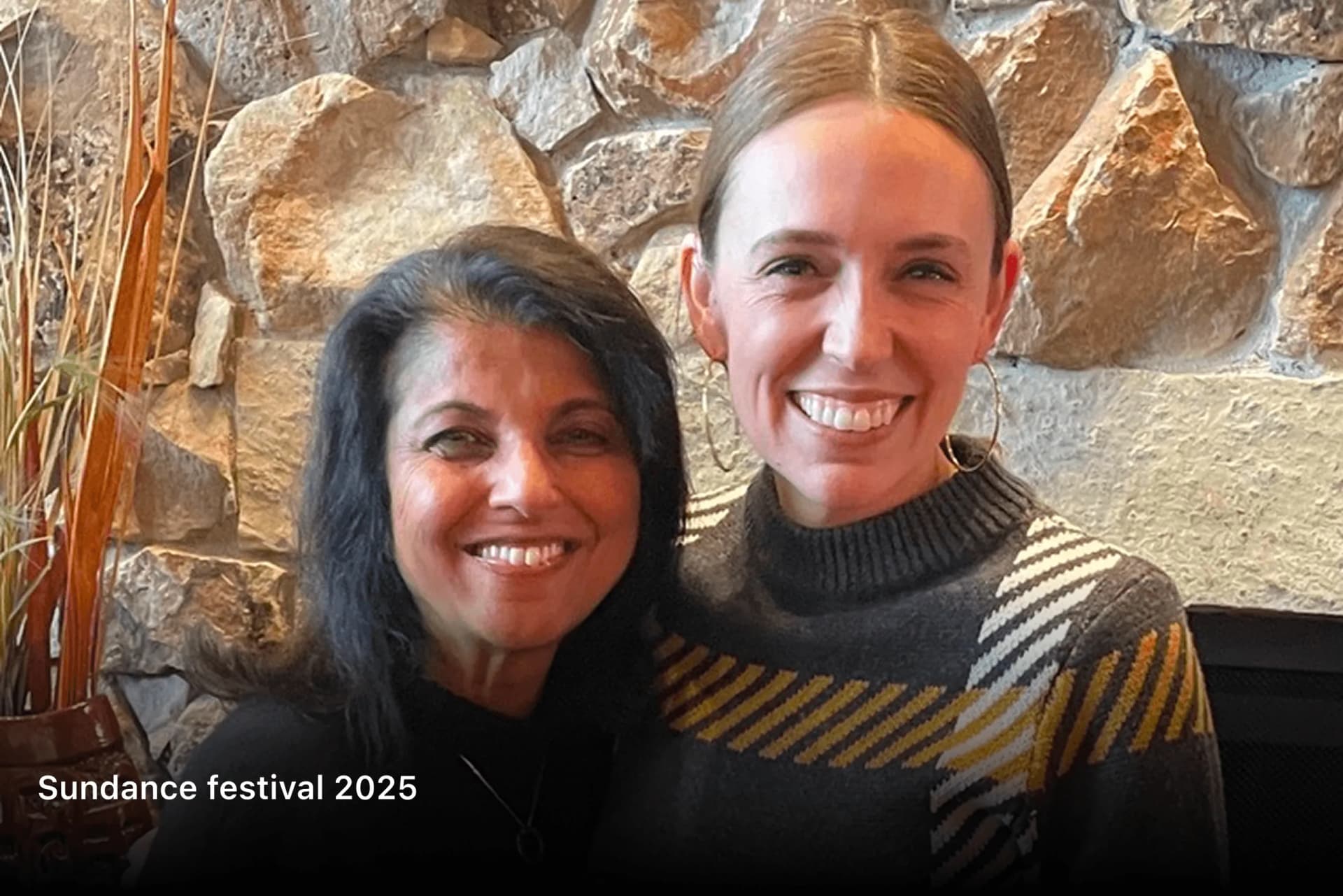 Shubhi Rao smiling with a guest beside a stone wall at Sundance Festival 2025