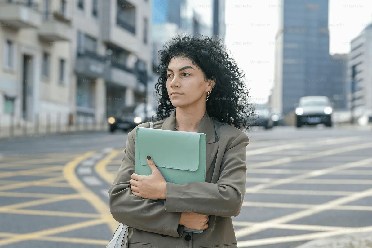 UP member holding a laptop on a city street